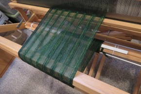 An experiment in collapse weave, on the loom. Note the crammed-and-spaced warp.